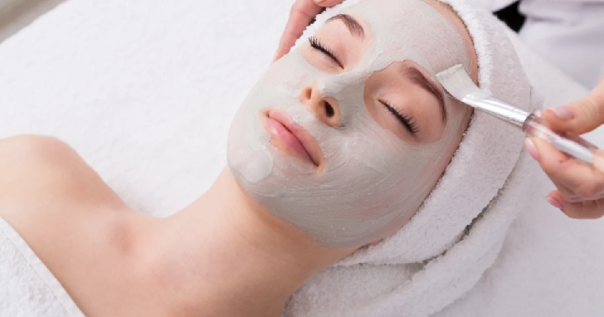 A woman receiving a professional facial treatment in St. Petersburg